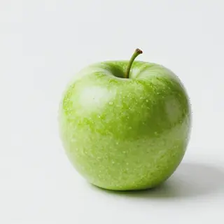 A ripe green apple on a seamless white background with soft 