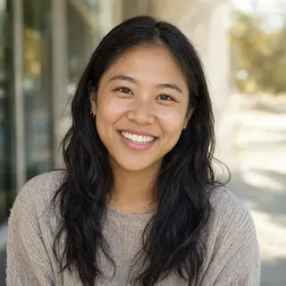 A close-up portrait of a young woman with a warm natural smi