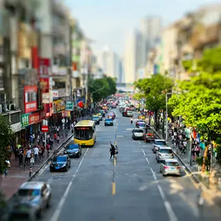 A tilt-shift photograph of a city street making real-life lo