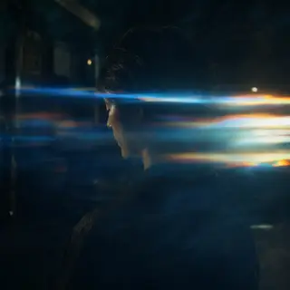 A cinematic frame with blue and orange anamorphic lens flare
