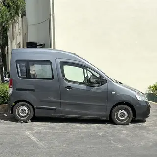 A car body with windows, doors, and headlights but no wheels