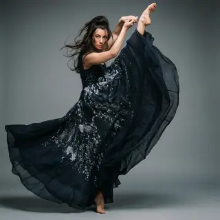 A dancer in a dynamic spin, dress flowing outward with one l
