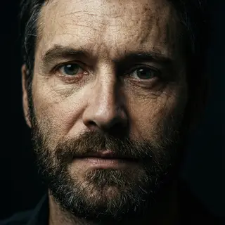 A portrait with dramatic split lighting — half the face brig