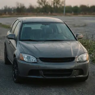 A car body with windows, doors, and headlights but no wheels