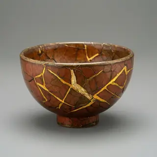 A Japanese kintsugi bowl — cracked ceramic repaired with vis