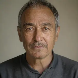 A portrait of a middle-aged man with a calm, serious express
