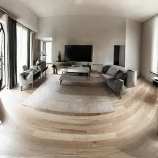 A wide-angle shot of a modern living room interior showing e