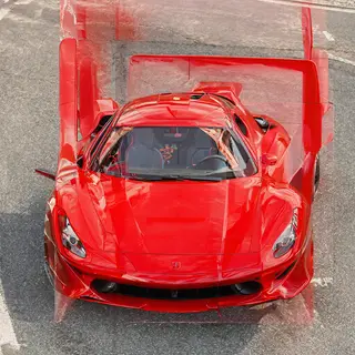 A bright red sports car parked on a gray asphalt road — the 