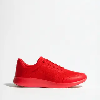 A single red sneaker on a clean white background with soft s