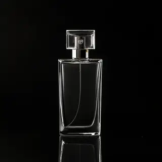 A clear glass perfume bottle on a reflective black surface w