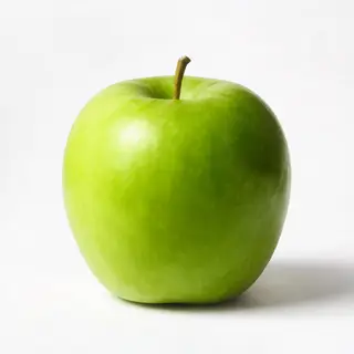 A ripe green apple on a seamless white background with soft 