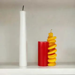 A tall thin white candle, a short fat red candle, and a medi