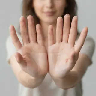 A woman holding her hands out in front of her palms-up, all 