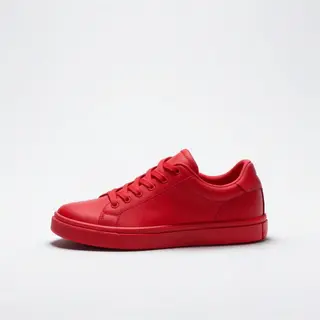 A single red sneaker on a clean white background with soft s