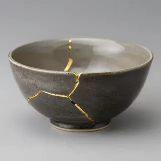 A Japanese kintsugi bowl — cracked ceramic repaired with vis