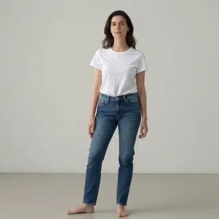 A woman standing upright in a relaxed pose, arms at her side