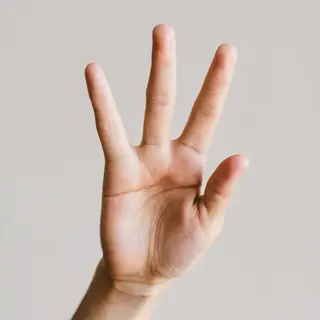 A person counting to three on their fingers, with index, mid