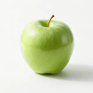 A ripe green apple on a seamless white background with soft 