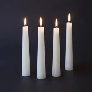 Exactly 4 white candles standing on a dark surface