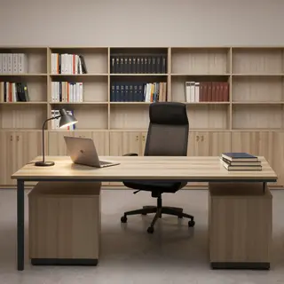 An office workspace with a desk, chair, bookshelf, and lamp 