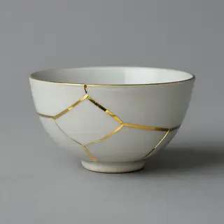 A Japanese kintsugi bowl — cracked ceramic repaired with vis