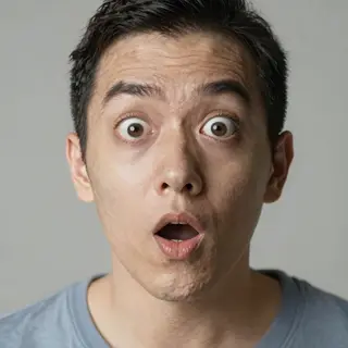 A portrait capturing genuine surprise — raised eyebrows, wid