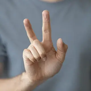 A person counting to three on their fingers, with index, mid