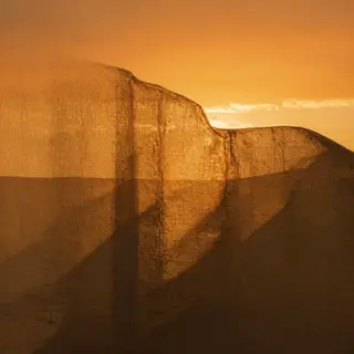 A landscape photograph bathed in golden hour light — long wa