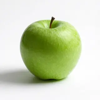 A ripe green apple on a seamless white background with soft 