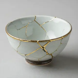 A Japanese kintsugi bowl — cracked ceramic repaired with vis