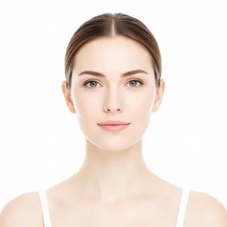 A high-key portrait of a person against a bright white backg