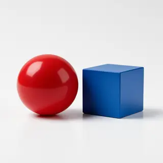 A red ball and a blue cube sitting side by side on a white s