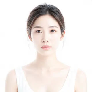 A high-key portrait of a person against a bright white backg