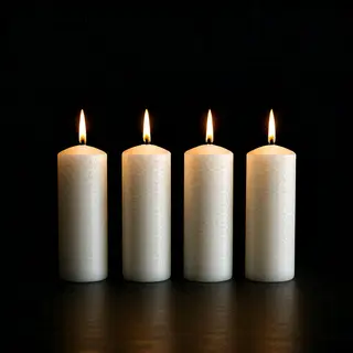 Exactly 4 white candles standing on a dark surface