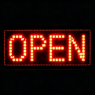 The word 'OPEN' displayed on a red LED sign with glowing pix