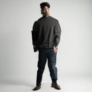 A man standing straight facing the camera, hands in pockets,