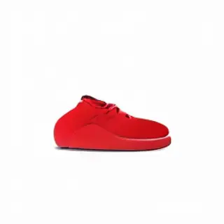 A single red sneaker on a clean white background with soft s