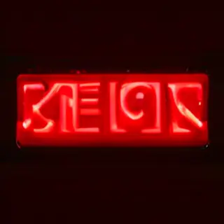 The word 'OPEN' displayed on a red LED sign with glowing pix