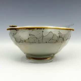 A Japanese kintsugi bowl — cracked ceramic repaired with vis