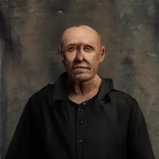 A portrait of a middle-aged man with a calm, serious express
