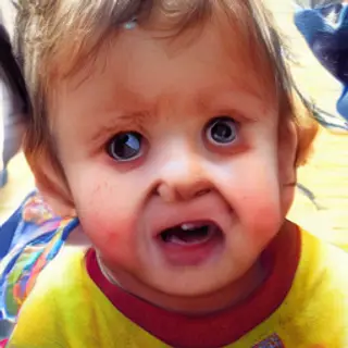 A 5-year-old child with round cheeks and large eyes, crying 