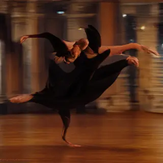 A dancer in a dynamic spin, dress flowing outward with one l