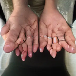 A woman holding her hands out in front of her palms-up, all 