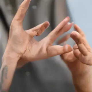 A person making a peace sign with their right hand, clearly 