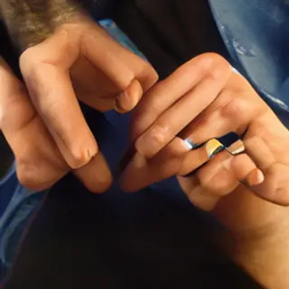 A person counting to three on their fingers, with index, mid