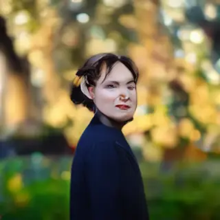 A portrait shot at 85mm f/1.4 with creamy bokeh background, 