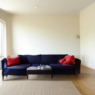 A minimalist room with walls in #F5E6CC (warm cream), a sofa