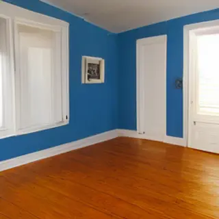 A room with walls in #4A90D9 (medium blue) with warm wooden 