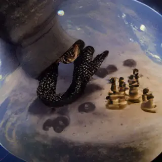 An octopus wearing a top hat and monocle playing chess on th