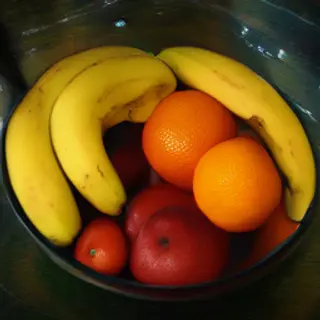 A fruit bowl containing exactly 3 bananas, 4 oranges, and 2 